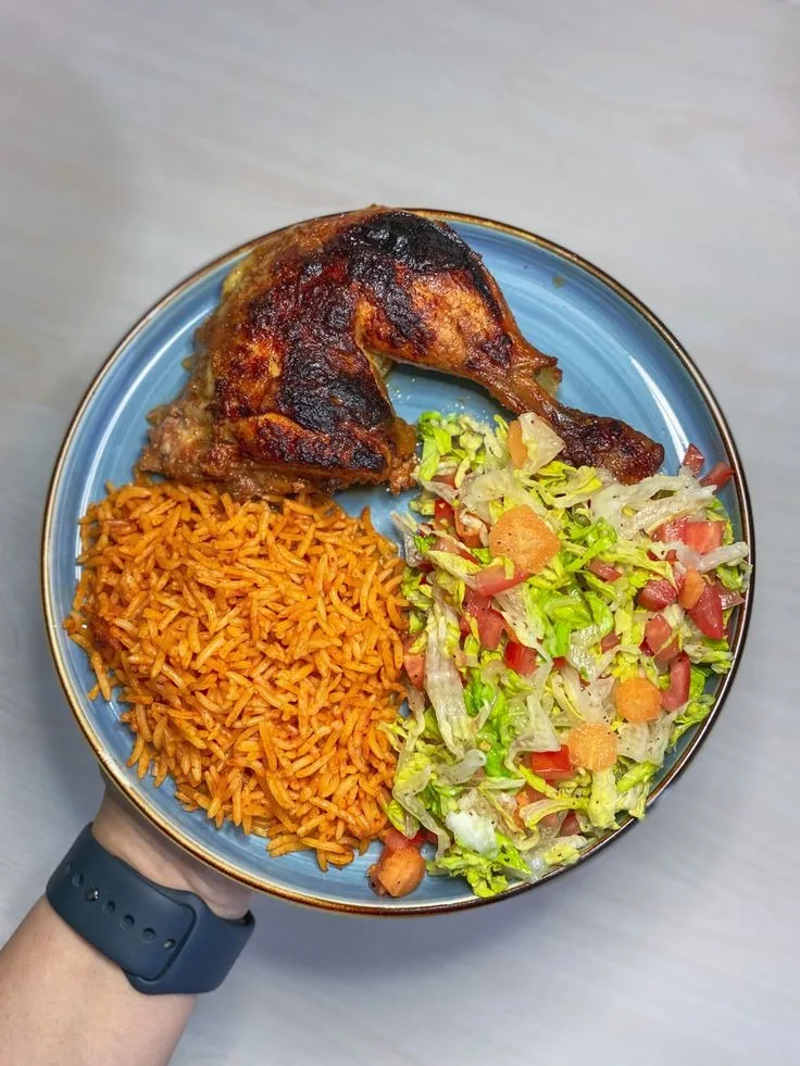 Delicious balanced Nigerian Jollof rice with grilled chicken and fresh salad